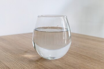 A glass of water on wooden table