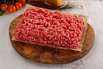 Raw minced beef meat over board
