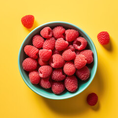 Organic, natural, fresh and healthy red raspberries in a fruit bowl, yellow fruit background 