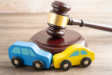 Hammer gavel judge with car vehicle accident, insurance coverage claim lawsuit court case.