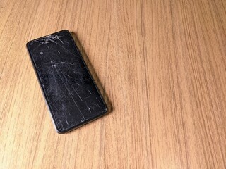an old cellphone with a cracked screen