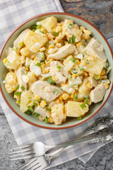 portion of chicken pineapple salad with the addition of corn, cheese, eggs and onions close-up in a plate on the table. Vertical top view from above