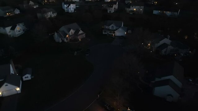 American cul de sac at night. Aerial shot of large houses in neighborhood at dark.