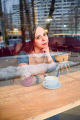 Woman Sitting at Table With Coffee