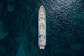 A large expensive white yacht is anchored, top view. White yacht Turquoise water air view. White...