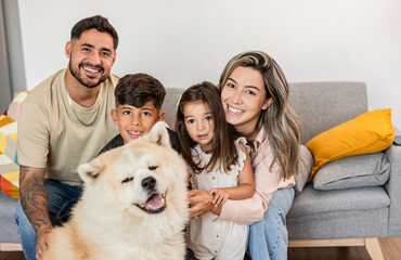 Joyous Family and Dog Posing for a Portrait at Home