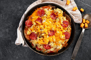 Trendy hybrid food. Mac and cheese pizza on dark background