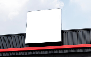 Mock up white light box billboard on building with blue sky background .clipping path for mockup