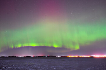 Polar lights over a snow field.