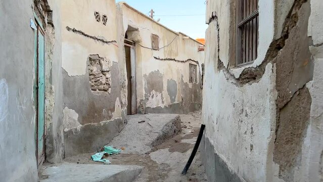 walking in desert city old town tropical climate ruins of mudbrick house Arabian culture traditional architecture design winding lane windcatcher ancient natural ventilation air flow historical house 