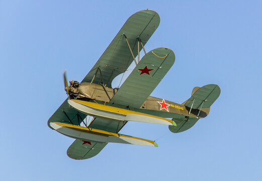 All-weather Soviet biplane seaplane Polikarpov Po-2/U-2 (NATO "Mule") in flight. against background of blue cloudless sky. Hydroaviation show - 2012. Gelendzhik, Russia - September 04, 2012