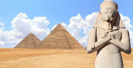 Horizontal banner with Stone pharaoh statue and famous Great Pyramids of Chephren and Cheops, Cairo, Egypt. Two Great Pyramids and ancient Ramses II statue, Giza pyramid complex (Giza Necropolis) - obrazy, fototapety, plakaty