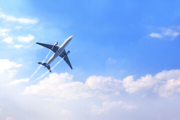 Horizontal nature background with aircraft and Jet trailing smoke in the sky. Airplane and...