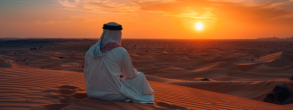 An Arab man looks at the desert. Selective focus.