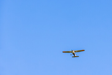 Propeller plane flying in a blue sky