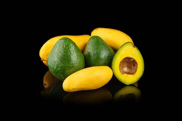 Mango and avocado on a black background