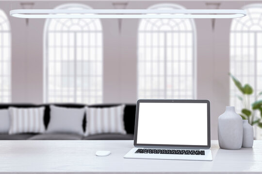 Laptop on white desk with blurred background, mockup for design presentation. 3D Rendering