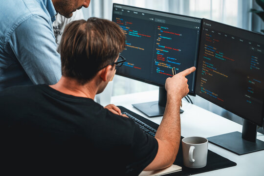 IT developers discussing online software development information on pc screen, creating program coding for latest version application on website. Concept of brainstorming firmware updated. Sellable.