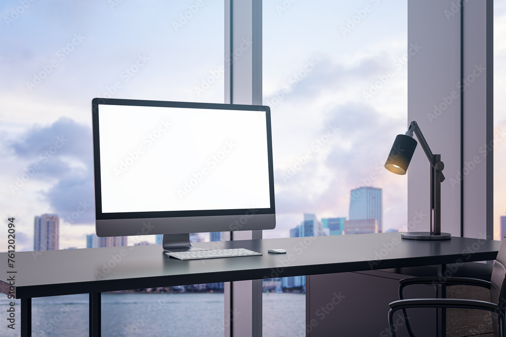 Poster Bright office interior with empty white computer monitor on desk and panoramic windows with beautiful city view and daylight. Mock up. Workplace concept. 3D Rendering.