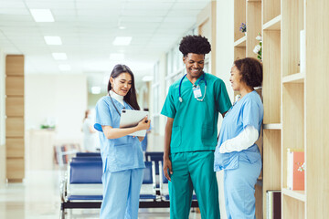 A group of young medical students with mixed-race surgeons examining these operations in a laptop.