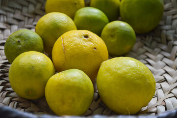 lemons and limes on the market, organic fresh new season fruit