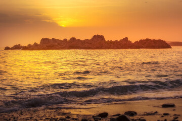 Sunset evening landscape with sea waves and rocky island in Montenegro, Sveti Stefan