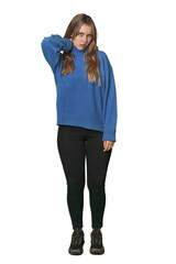 Studio portrait of a blonde Caucasian woman touching back of head, thinking and making a choice.