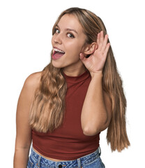 Fototapeta premium Studio portrait of a blonde Caucasian woman trying to listening a gossip.