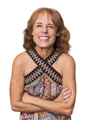 Redhead mid-aged Caucasian woman in studio laughing and having fun.