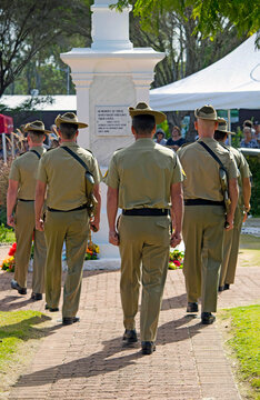 Australian Army soldiers slow marching towards ANZAC Day military memorial cenotaph in front of a crowd in Cooroy Queensland