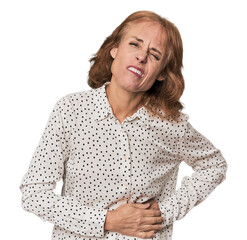 Redhead mid-aged Caucasian woman in studio having a liver pain, stomach ache.