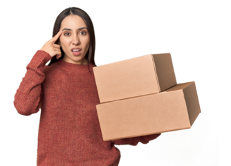 Caucasian young woman with moving boxes on studio background showing a disappointment gesture with forefinger.