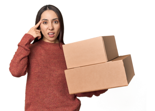 Caucasian young woman with moving boxes on studio background showing a disappointment gesture with forefinger. - Powered by Adobe