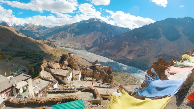 4K Landscape shot of river under the Snowy mountain peaks during a cloudy day with blue sky as seen from top of the Dhankar Monastery in Spiti Valley, Himachal Pradesh, India. Monastery in mountains.