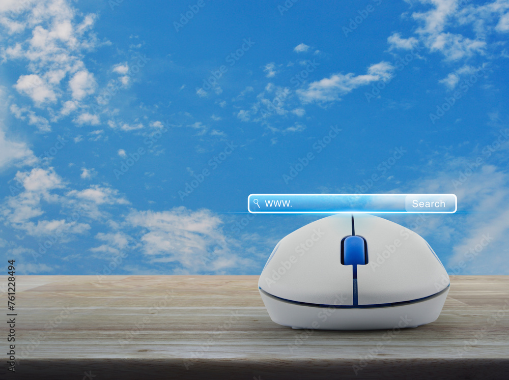 Poster search www button with wireless computer mouse on wooden table over blue sky with white clouds, sear