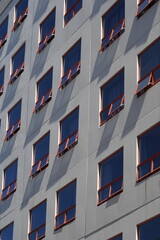 Fototapeta premium A tall building with identical windows in inner city