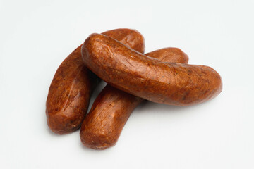 pile of red smoked beef sausage isolated on a white background