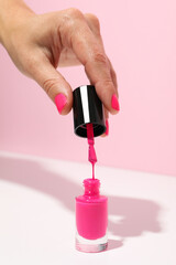 Pink nail polish with a woman's hand