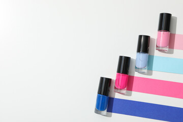 Multicolored nail polishes on a white background
