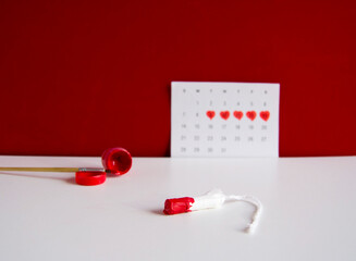 Tampon in red paint.Concept of critical days,menstrual pain,menstruation,menstrual...