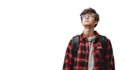 A young man with glasses and a plaid shirt looks contemplative while standing outdoors