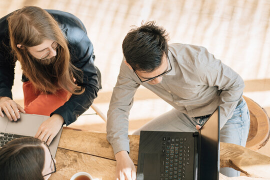 Programmer showing laptop to colleagues at office