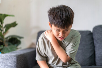 Child experiencing back pain, subtly conveying themes of health, discomfort, and the need for care in childhood, lower back with a pained expression, health and wellness, children's physical health