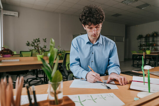 Engineer drawing diagram on paper in office