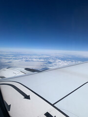view from aircraft to the ocean and snow covered landscape of Iceland