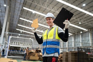 Caucasian businessman or foreman worker checking Kraft paper stock with forklift background at warehouse	 - 761260221