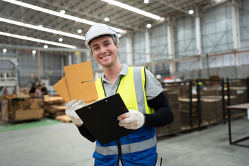 Caucasian businessman or foreman worker checking Kraft paper stock with forklift background at warehouse	 - 761260281