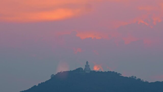 Phuket big Buddha on a hilltop at sunset Phuket Big Buddha is a symbol of peace and serenity. It's located on a hilltop overlooking the city and is a popular tourist attraction..popular landmark.