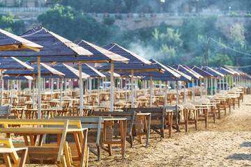 Long row of tables and sun umbrellas at the Bilgah beach near Baku