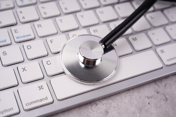 Health and medical or management stability concept. A stethoscope placed on a keyboard. Blurred...